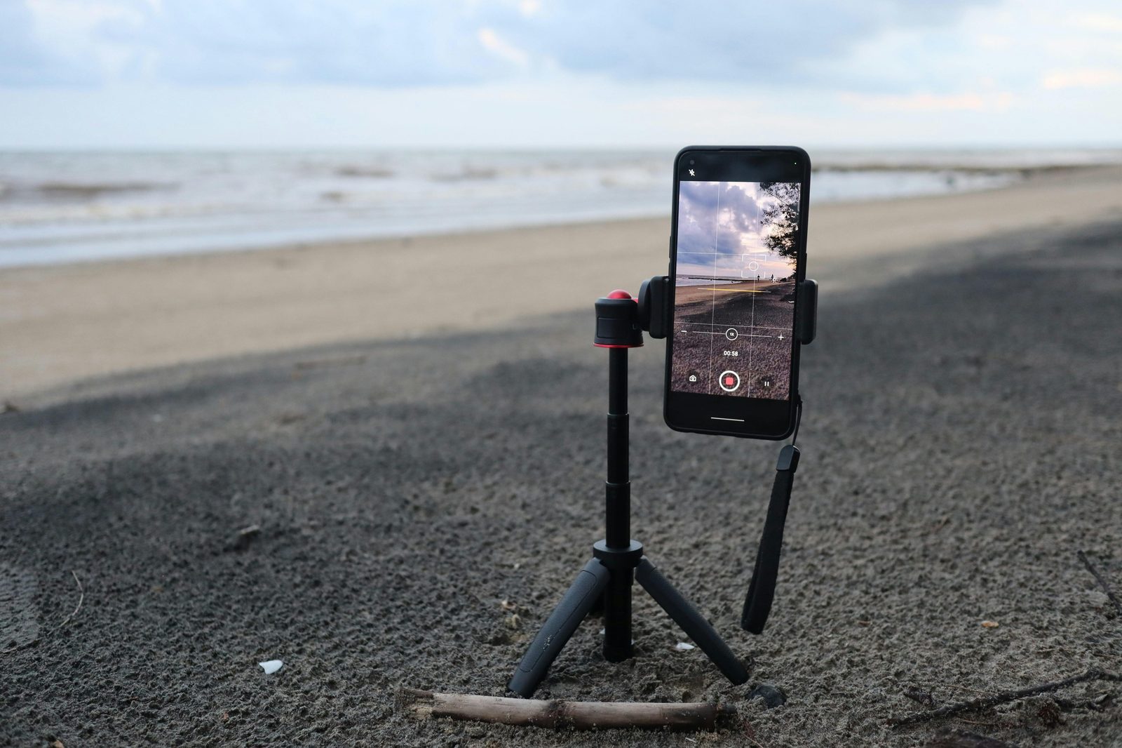 Phone on tripod capturing a beach scene
