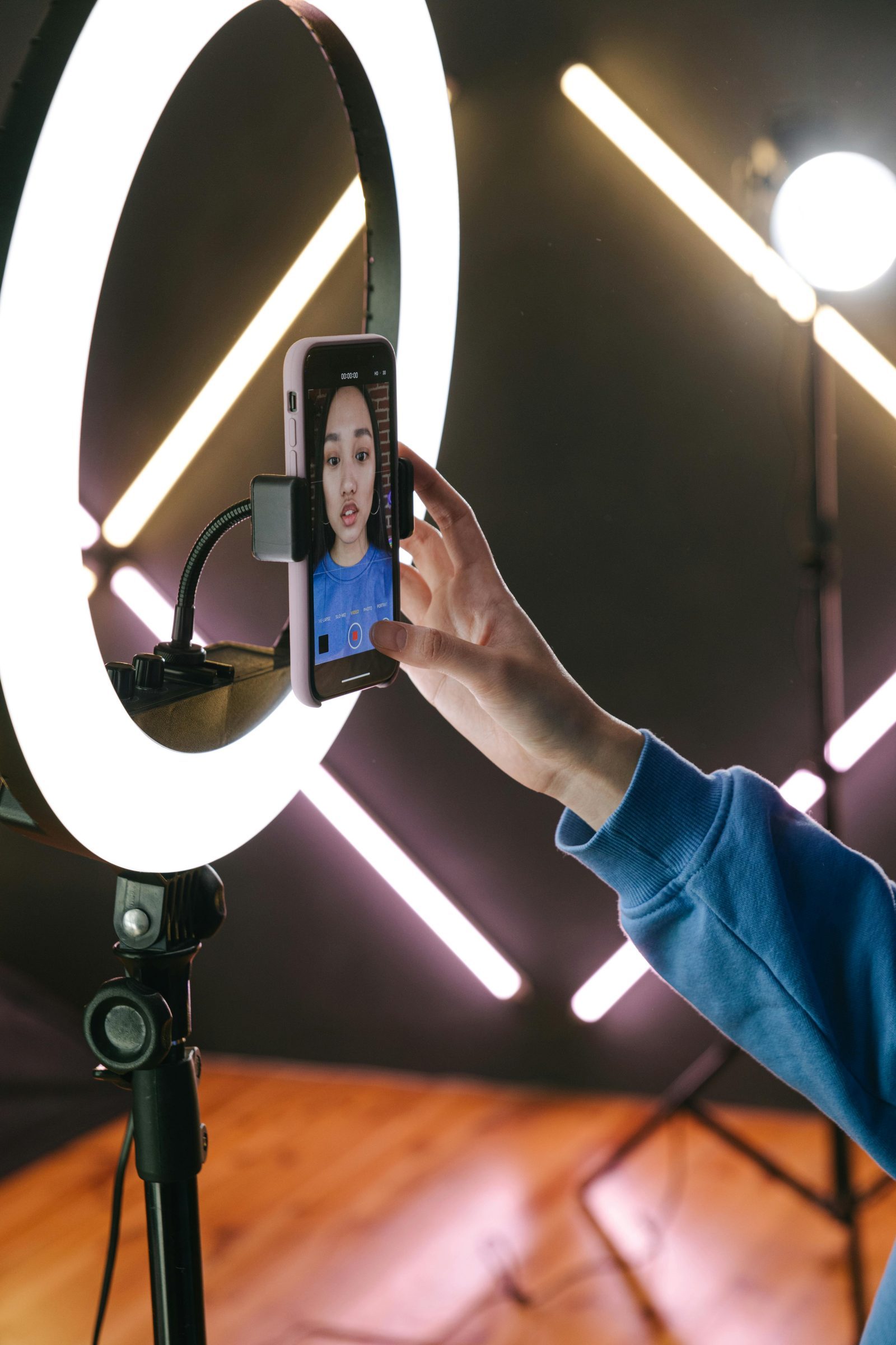 Creator filming with ring light and smartphone